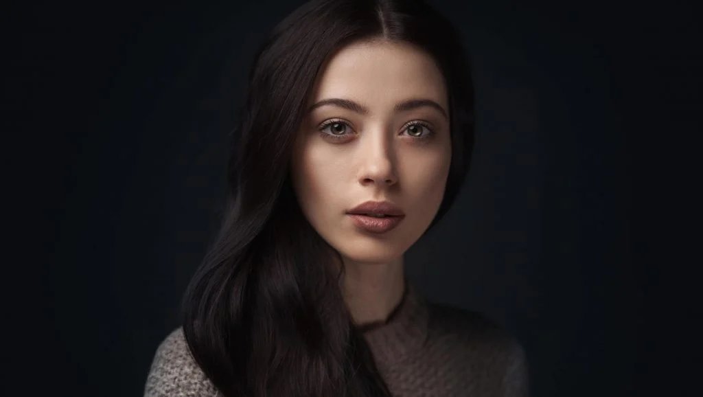 Studio portrait of a woman against a dark background